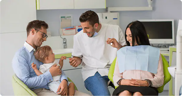 Dentist talking with a family in the treatment room