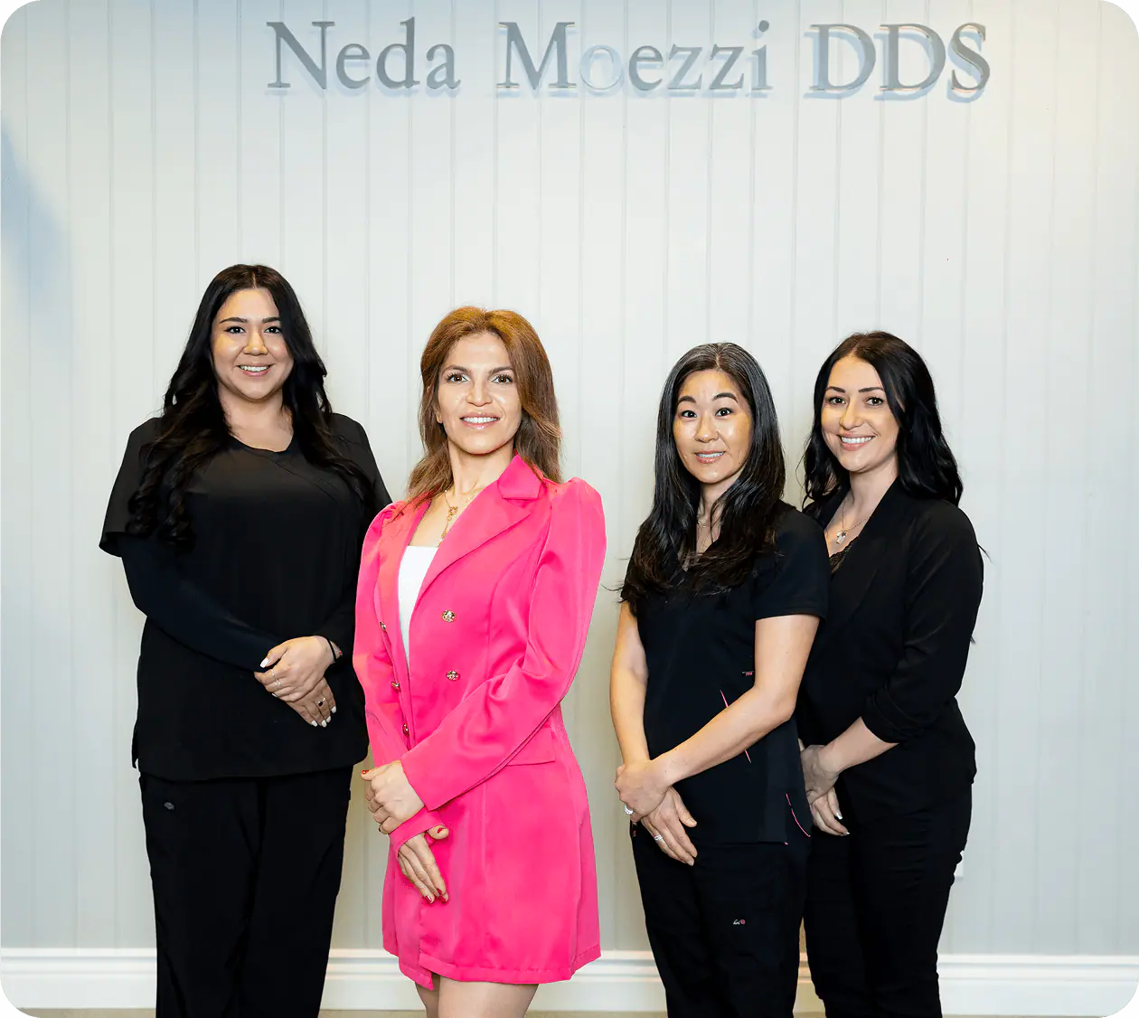 Dr. Neda Moezzi and her team in front of the Neda Moezzi DDS sign