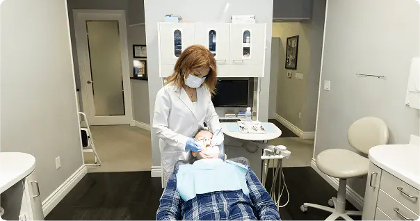 Dr. Neda Moezzi treating a patient in the office