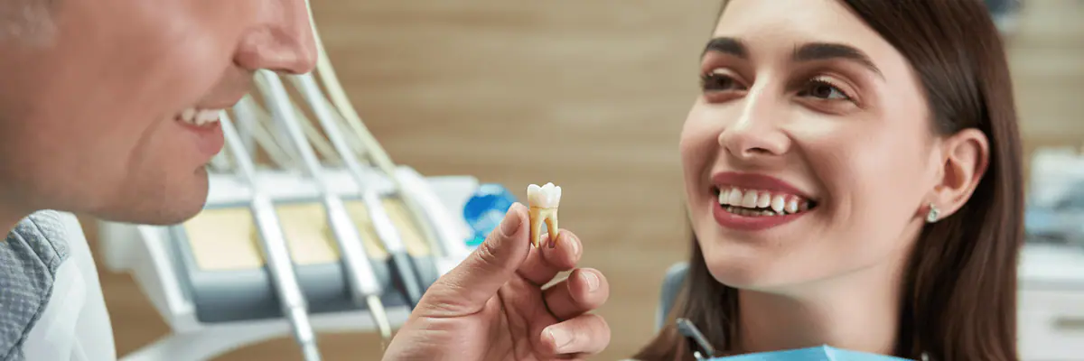 Dentist showing a patient a dental crown